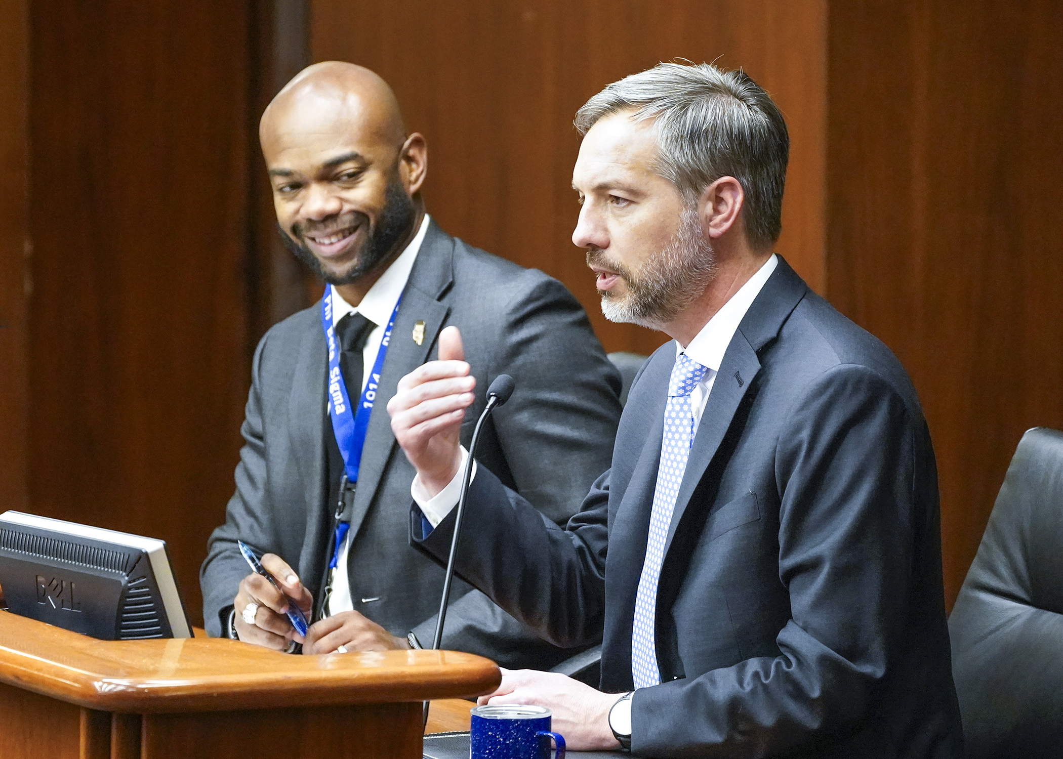 Department of Employment and Economic Development Commissioner Matt Varilek testifies April 24 before the House workforce committee in support of a bill sponsored by Rep. Cedrick Frazier, left, to modify Minnesota paid leave law provisions. (Photo by Andrew VonBank)
